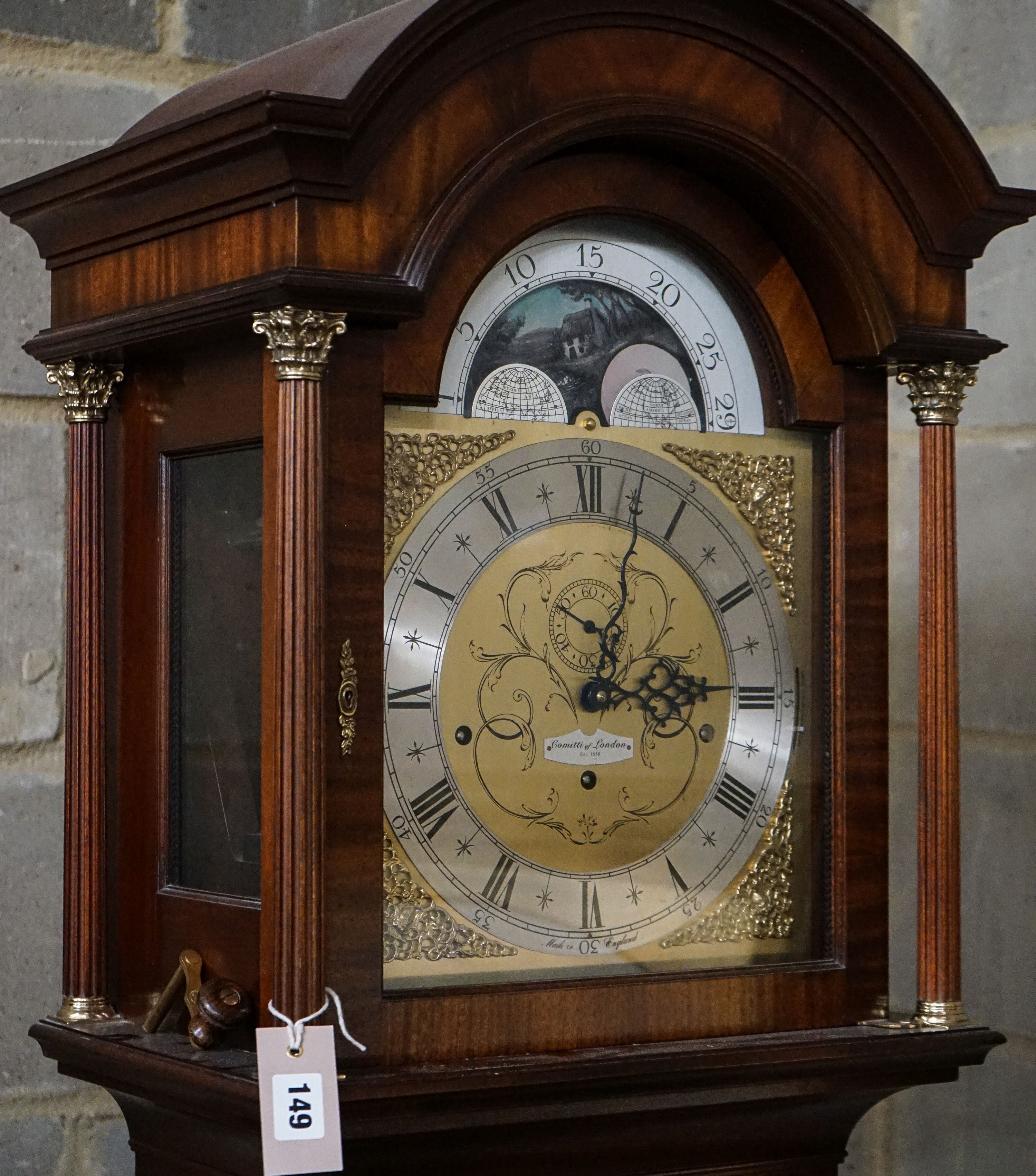 A modern mahogany longcase clock by Comitti London eight day, striking and chiming movement, brass dial with rocking ship automaton, the case with bulls-eye door, height 203cm